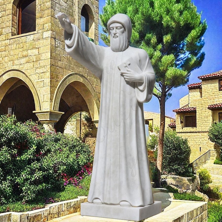 saint Charbel statue with bible outdoor