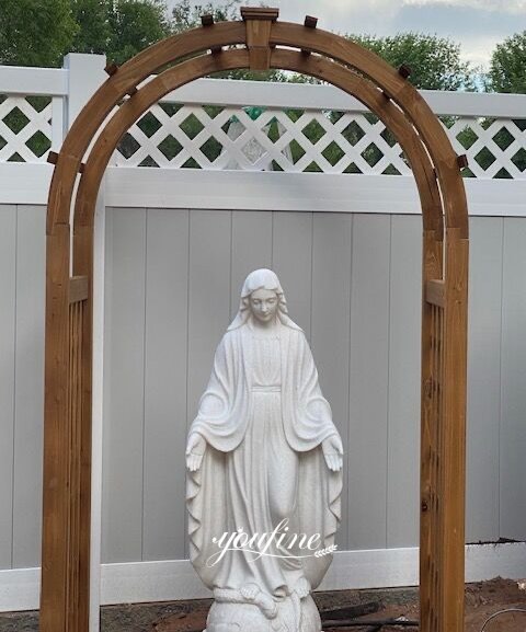 A Mary statue placed in a beautiful garden niche