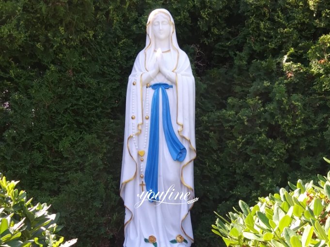 Close-up of a marble Mary statue's serene face