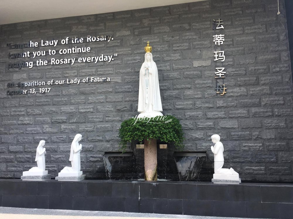 A sculpture of Our Lady of Fatima and three shepherd children