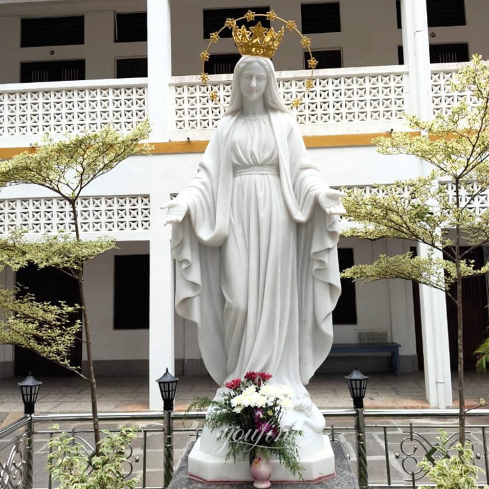 A sculpture of the Virgin Mary in a community
