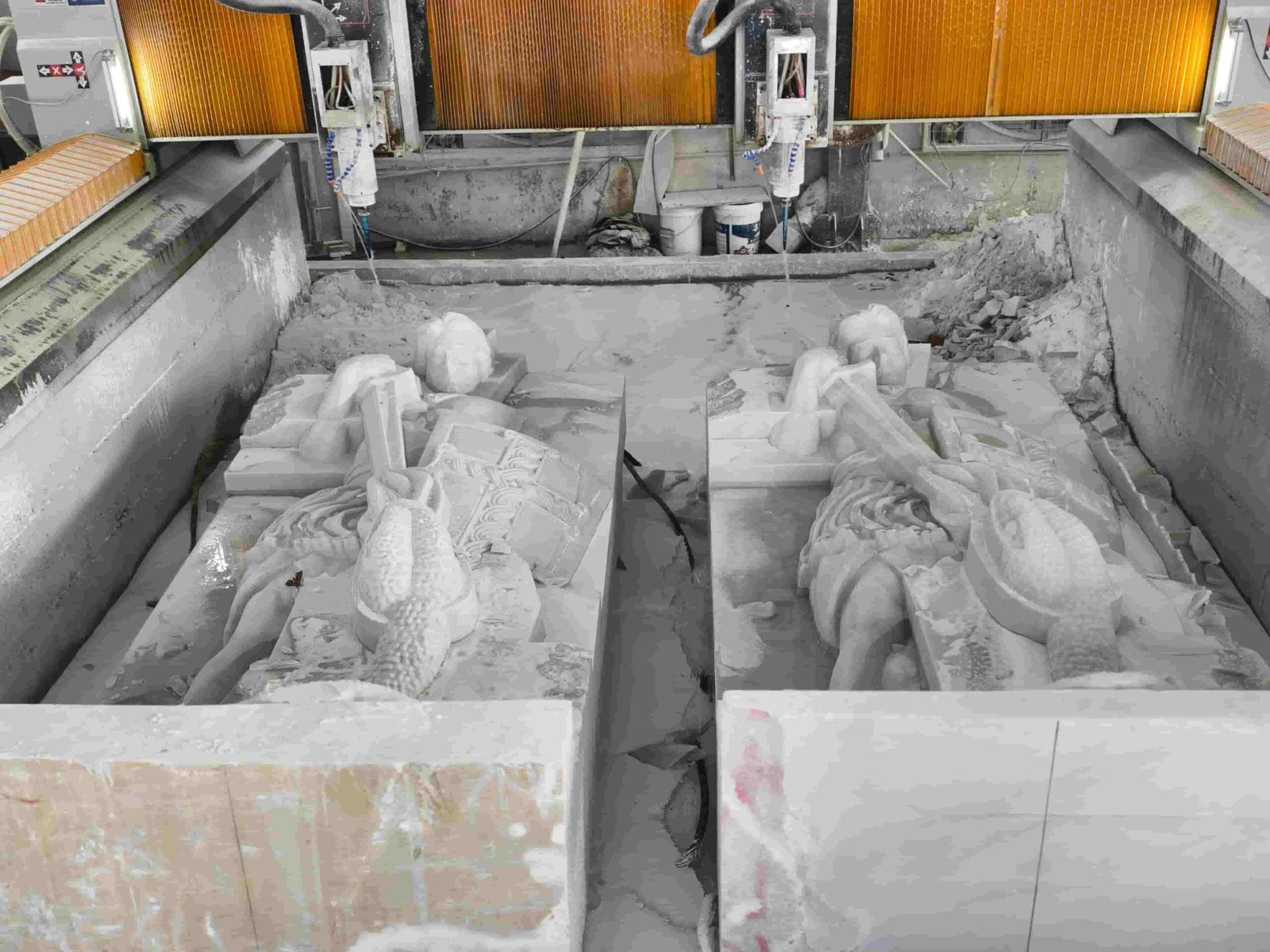 Large Saint Michael statue carving process and details 02 — two marble blocks rough-carved in the CNC water bath