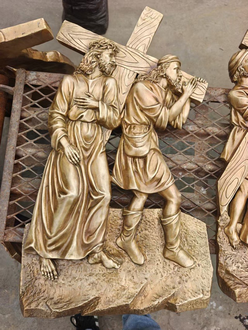 Gold-colored relief, Station V — Simon helps Jesus carry the cross