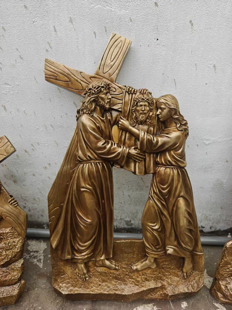 Gold-colored relief, Station VI — Veronica wipes the face of Jesus